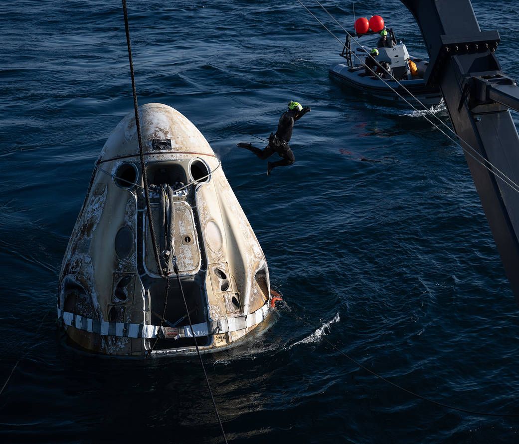 Support teams work around the SpaceX Crew Dragon Freedom spacecraft shortly after it landed with NASA astronauts Kjell Lindgren, Robert Hines, Jessica Watkins, and ESA (European Space Agency) astronaut Samantha Cristoforetti aboard in the Atlantic Ocean off the coast of Jacksonville, Florida, Friday, Oct. 14, 2022. Lindgren, Hines, Watkins, and Cristoforetti are returning after 170 days in space as part of Expeditions 67 and 68 aboard the International Space Station. Photo Credit: (NASA/Bill Ingalls)